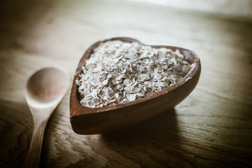 closeup.muesli and wooden spoon on a wooden table.