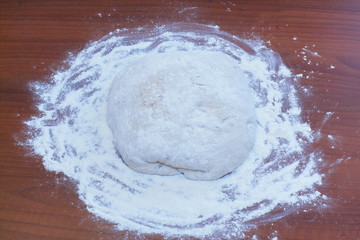 Old homemade recipes. Homemade yeast rye dough with flax, sesame and sunflower seeds on natural brown wooden background.