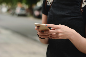 Young women sending message with smartphone.