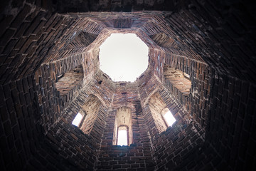 Old ruined castle tower. Bottom view from inside, looking up in tower ruin