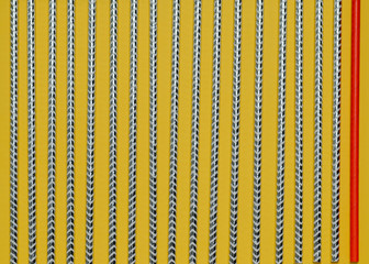 Background of one red tube on the right and bright striped on yellow background.