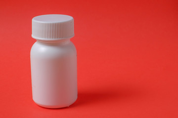 White bottles on red background