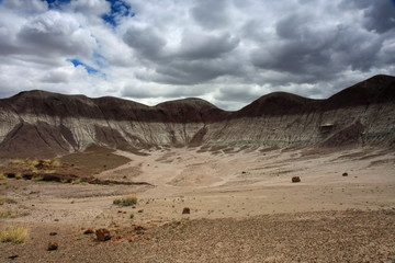 Badlands of the Painted Desert under a gathering rain storm in Petrified Forest National Park, Arizona.