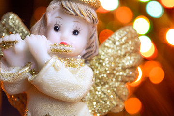 Angel with gold wings on background of bokeh lights. Christmas, New Year picture