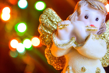 Angel with gold wings on background of bokeh lights. Christmas, New Year picture