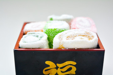 Delicious rolls of Lokum with fruit marmalade in japanese style in black box
