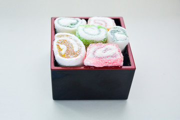 Delicious rolls of Lokum with fruit marmalade in japanese style in black box