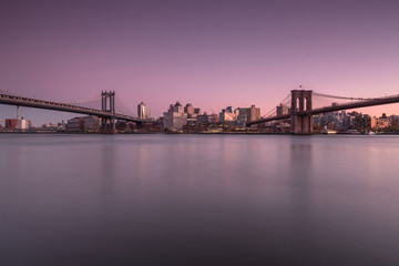 Fototapeta na wymiar View on Dumbo location with Manhattan Bridge and Brooklyn Bridge from east river at sunset 