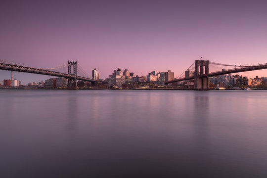 View on Dumbo location with Manhattan Bridge and Brooklyn Bridge from east river at sunset 