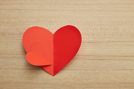 Valentine's day red paper heart on wooden