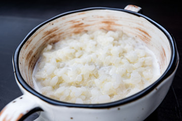 rice pudding in white plate on dark background