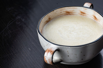 Semolina porridge in a vintage Breakfast bowl on a dark wooden table.
