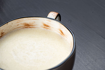 Semolina porridge in a vintage Breakfast bowl on a dark wooden table.