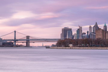 Fototapeta na wymiar Manhattan and Brooklyn bridge view from east river long exposure