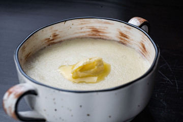 Semolina porridge in a vintage Breakfast bowl on a dark wooden table.