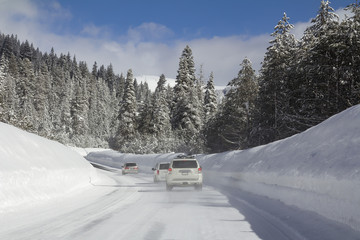 Fototapeta na wymiar Winter road with cars in snowy forest.