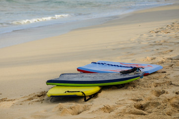 Grouping of 3 boogie boards on Waimanalo Beach in Oahu, Hawaii