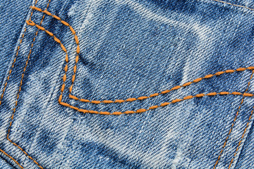 Denim fabric texture with yellow stitching
