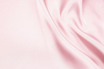 The texture of the satin fabric of pink color for the background