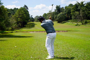 Golfer playing golf in beautiful golf course in the evening golf course with sunshine in thailand