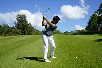 Golfer playing golf in beautiful golf course in the evening golf course with sunshine in thailand