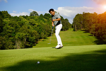 Fototapeta premium Golfer playing golf in beautiful golf course in the evening golf course with sunshine in thailand