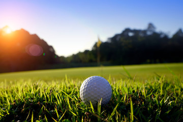 Golf ball on green in beautiful golf course at sunset background. Golf ball on green in golf course at Thailand