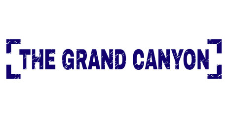 THE GRAND CANYON tag seal imprint with corroded style. Text tag is placed between corners. Blue vector rubber print of THE GRAND CANYON with grunge texture.
