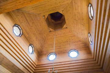 Wooden dome with round Windows and light coming through them