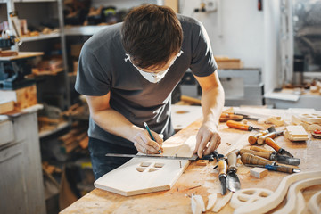 The carpenter works with a tree