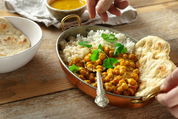 Asian lunch Asian food Chickpea curry rice quinoa pan wooden table healthy - obrazy, fototapety, plakaty