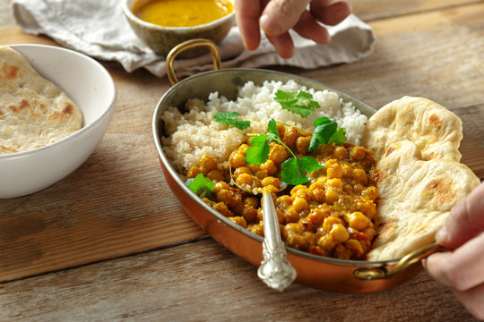 Asian lunch Asian food Chickpea curry rice quinoa pan wooden table healthy