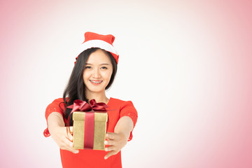 Photo of asian curious woman in red dress rejoicing her birthday or new year gift box. Young woman holding gift  box with red bow being excited and surprised  holiday present isolated white background
