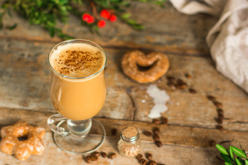 coffee with milk - cappuccino (cup of coffee) arabica in a transparent cup on a wooden table. Top...