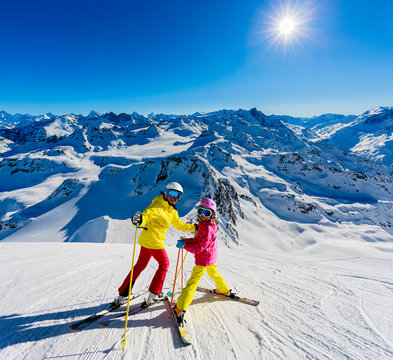 Happy family enjoying winter vacations in mountains . Ski, Sun, Snow and fun.