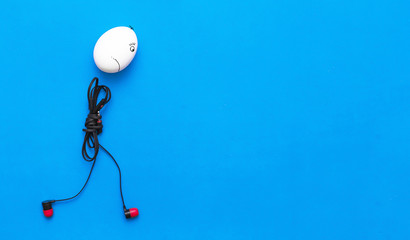 Sad chicken egg man with headphones body is walking away on the blue background.
