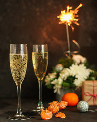 champagne glasses, sparklers and a bunch of cets (holiday), top view. copy space
