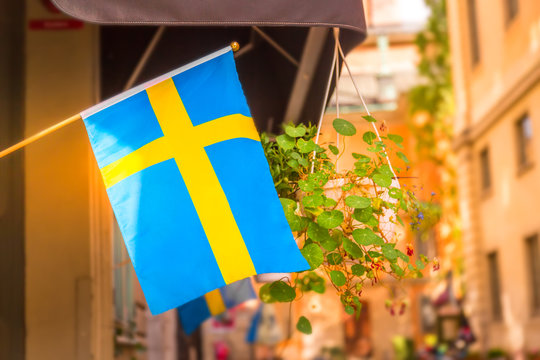 Sweden flag on a street in the Gamla Stan, old town of Stockholm, Sweden.