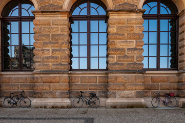 old window on brick wall and bikes