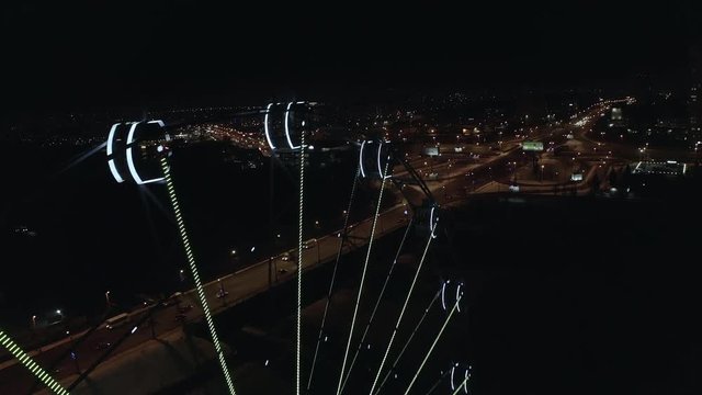 Aerial; drone flight along the night cityscape illuminated ferris wheel on background; Chelyabinsk, Russia