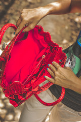 Woman with luxury snakeskin python handbag in the tropical forest. Bali island.