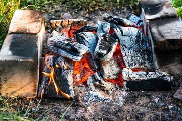 Burning coals and bricks in a camp in nature