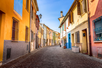 Fototapeta na wymiar Narrow street of the village of fishermen San Guiliano with colorful houses and bicycles in early morning in Rimini, Italy.