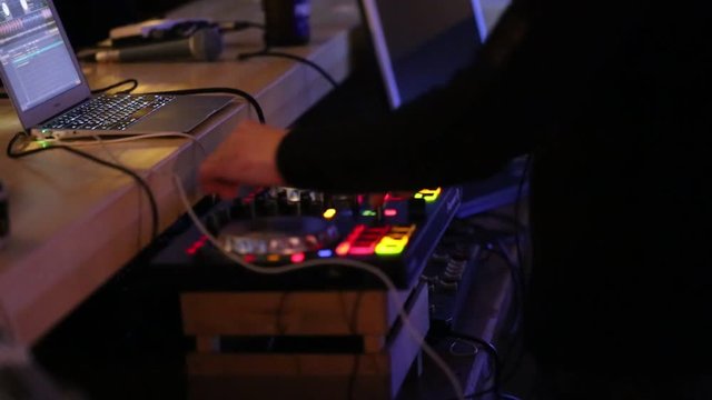 Hands on mixing console in music recording studio