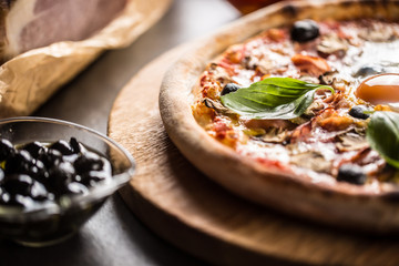 Pizza capricciosa capricious traditional italian meal from prosciutto mushrooms artichokes egg parmesan olives and basil