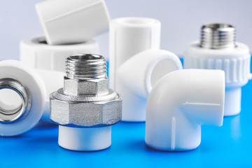 Polypropylene. Plumbing parts, accessories and tools on a blue white background.