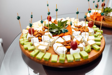 Tasting cheese dish . Delicious cheese on the table. Table setti