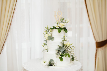  White wedding cake with flowers.  The word Love with heart.