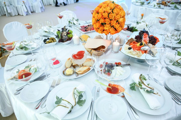 Holiday table setting decorated with flowers and candles.