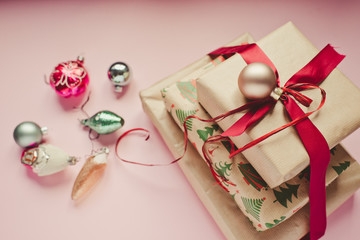 Christmas presents with red ribbon on a wooden background/toned photo